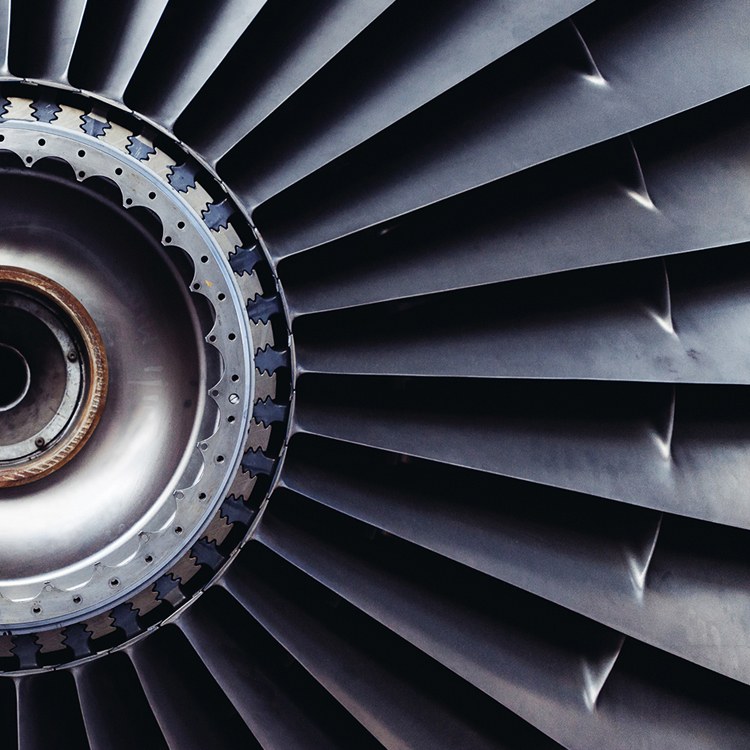 Close-up of a metal additive turbine fan hub with fir-tree style blade roots