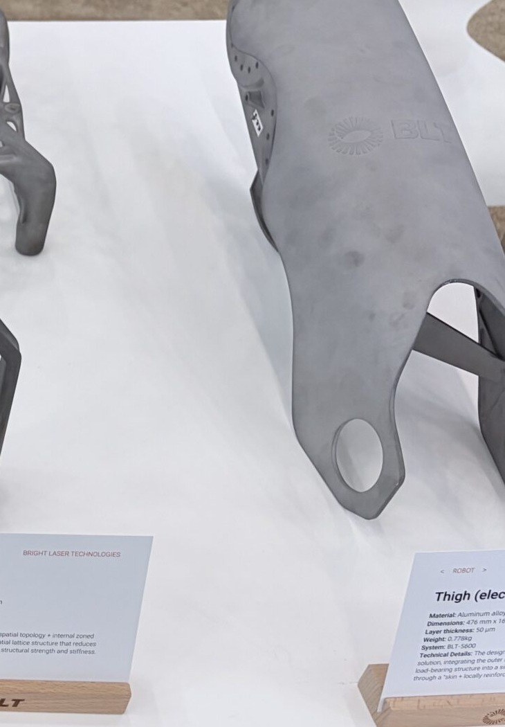 Curved metal additive robot thigh drive shell with integrated skin reinforcements