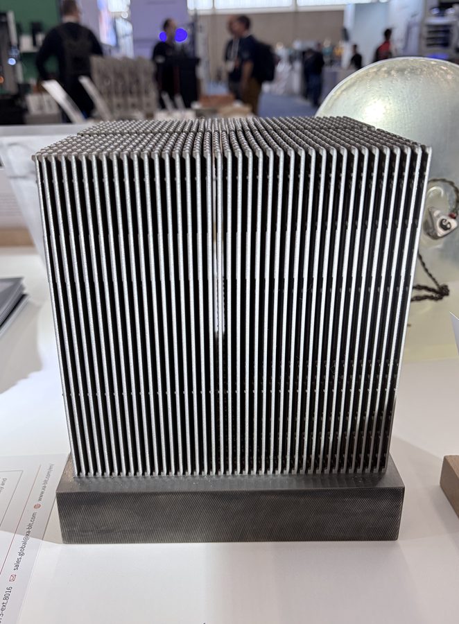 Metal additive quad-fin heat-exchanger block blank on an exhibit table